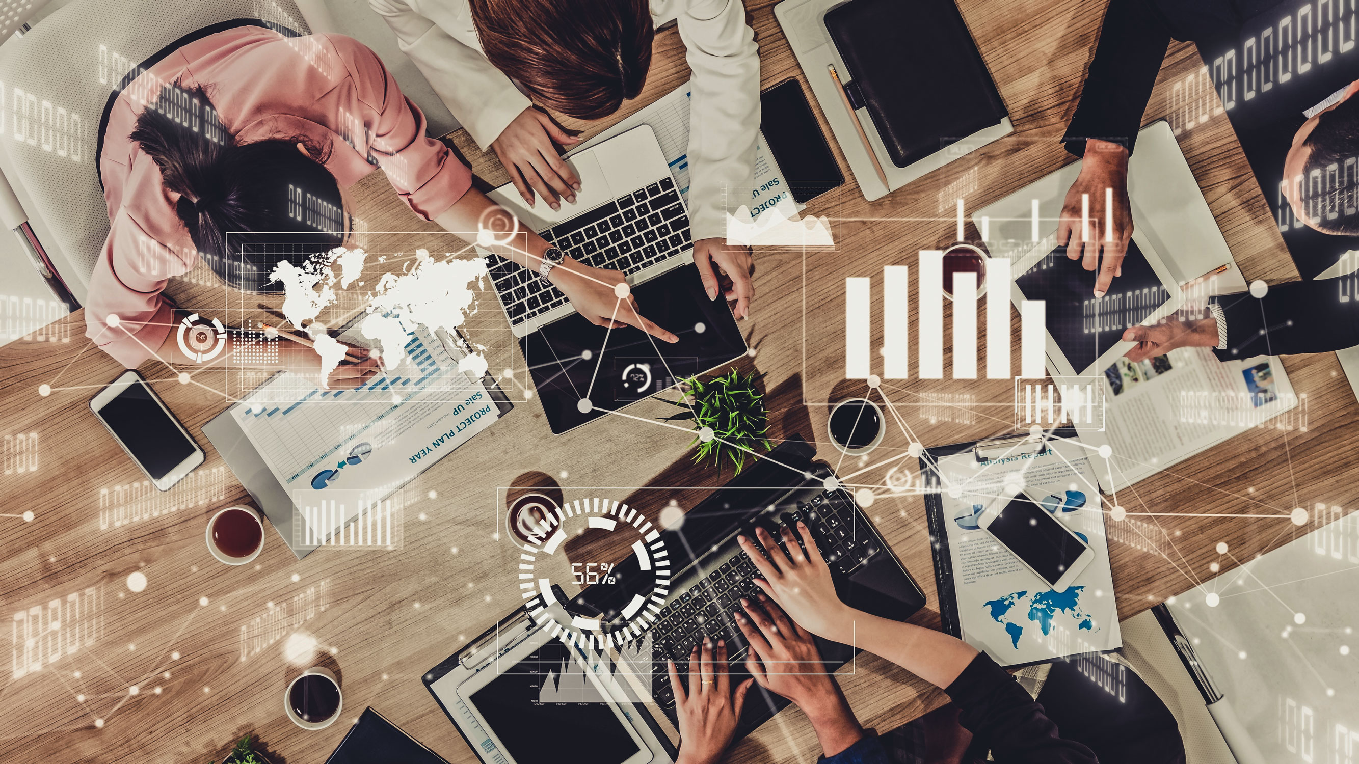 Bird's-eye view of an office meeting with graph overlays